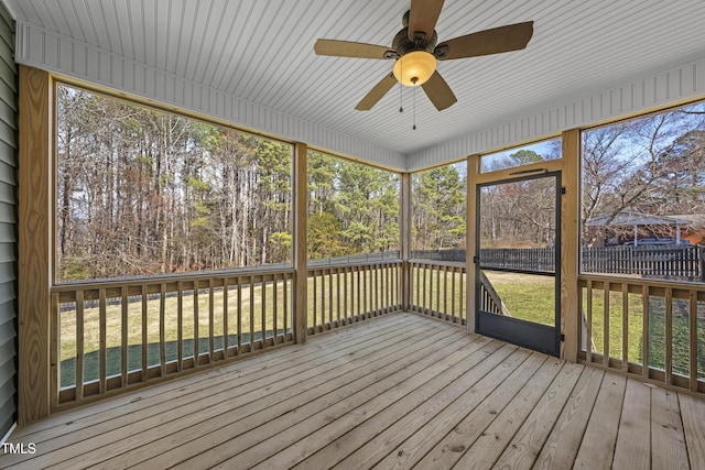 unfurnished sunroom featuring ceiling fan