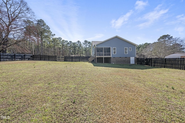 view of yard featuring a sunroom and a fenced backyard