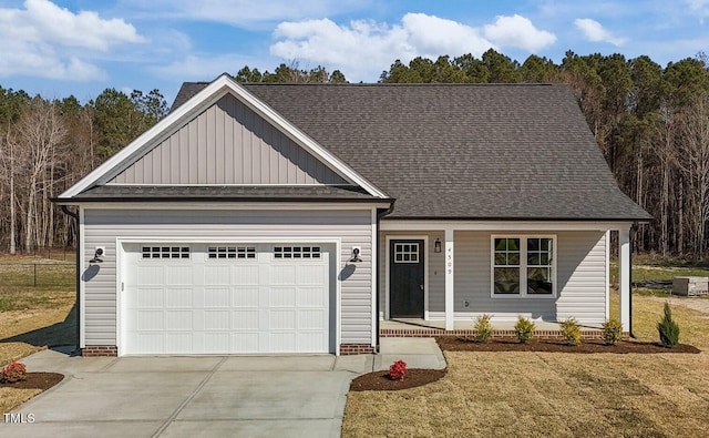 view of front of property with cooling unit, a garage, covered porch, and a front yard