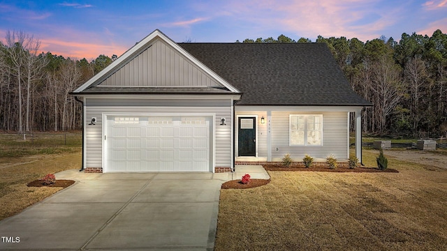 view of front facade with a garage and a yard