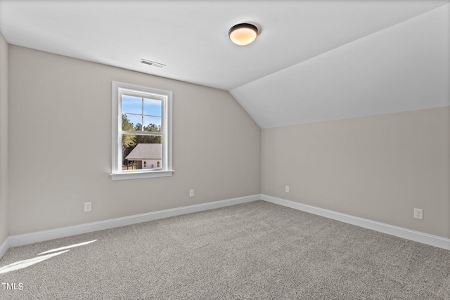 bonus room featuring carpet flooring and vaulted ceiling