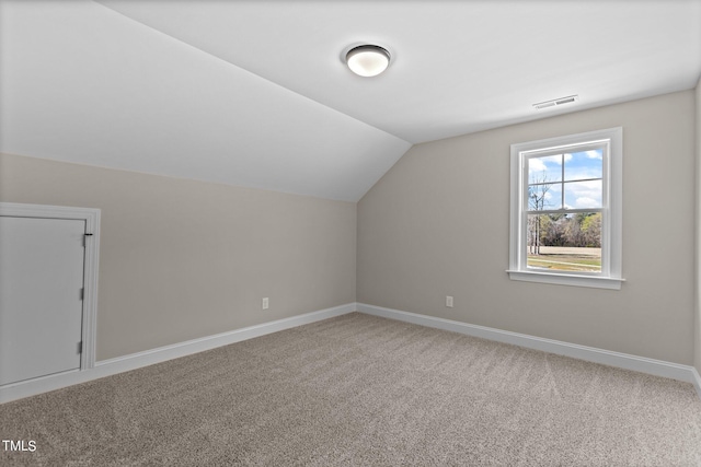 bonus room with lofted ceiling and carpet flooring