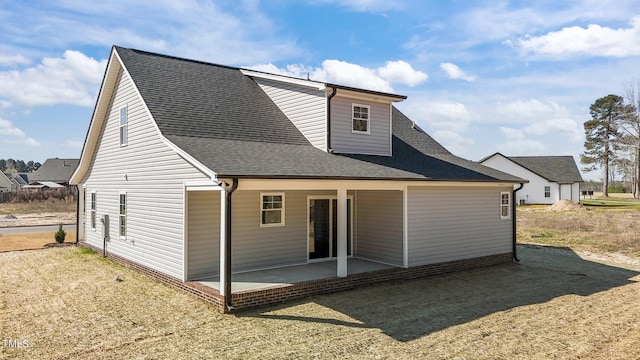 rear view of house featuring a patio area and a lawn