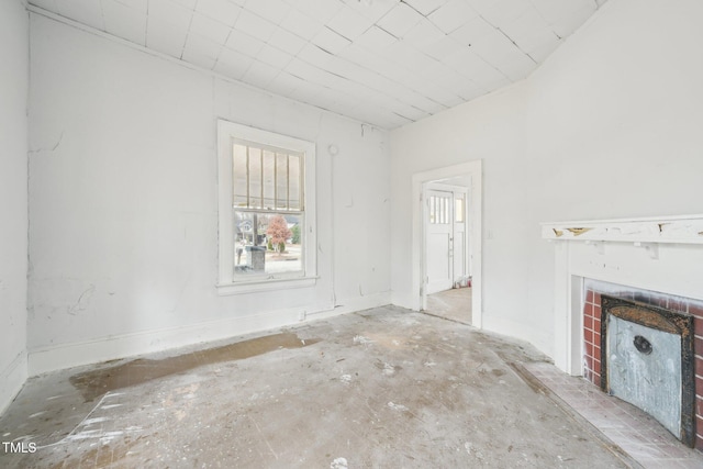 unfurnished living room featuring a brick fireplace