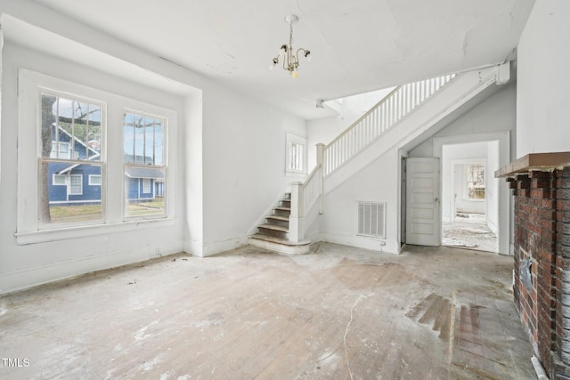 unfurnished living room with a chandelier