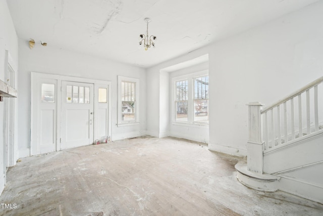 unfurnished living room with an inviting chandelier