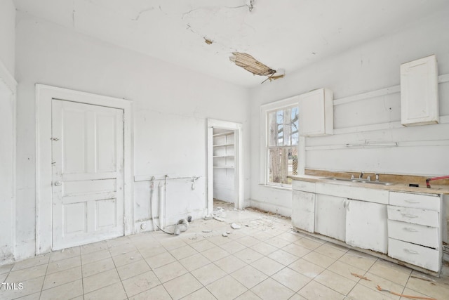 kitchen featuring sink and white cabinets