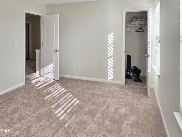 unfurnished bedroom with carpet floors, baseboards, and a closet