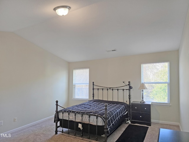 carpeted bedroom featuring visible vents, vaulted ceiling, baseboards, and multiple windows