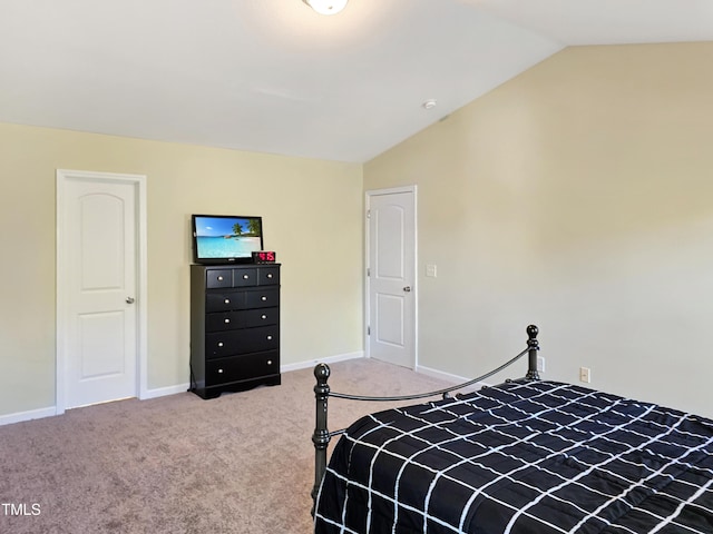 bedroom with lofted ceiling, carpet flooring, and baseboards