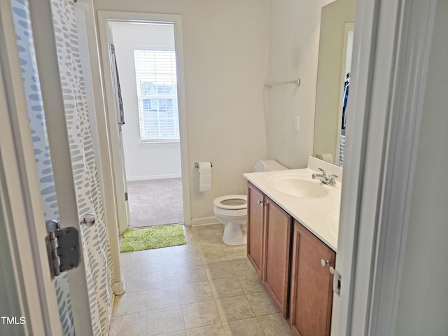 full bath with baseboards, vanity, toilet, and tile patterned floors