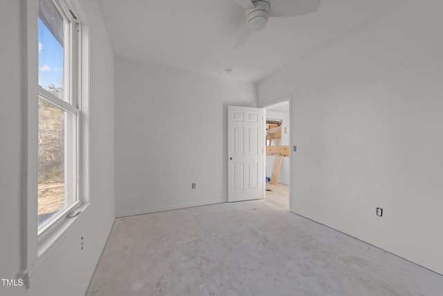 spare room featuring a healthy amount of sunlight and ceiling fan