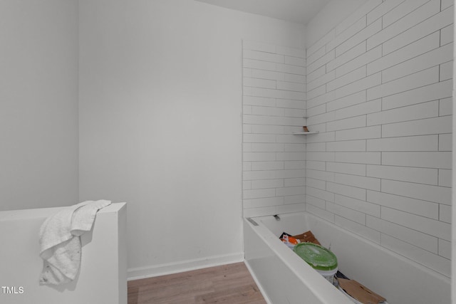 bathroom featuring a bath and hardwood / wood-style floors