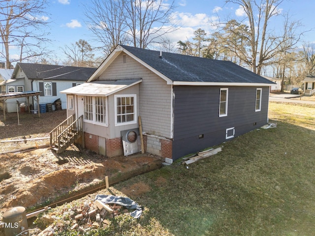 view of side of home with a yard