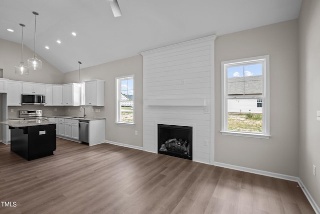 4519 Sweet Williams Ln Unit 153, Wilson, NC 27896 - kitchen featuring a kitchen island, pendant lighting, white cabinetry, a kitchen bar, and stainless steel appliances