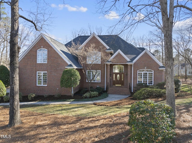 traditional-style home with a front yard and brick siding