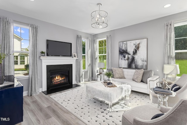 living room featuring a wealth of natural light and light hardwood / wood-style flooring