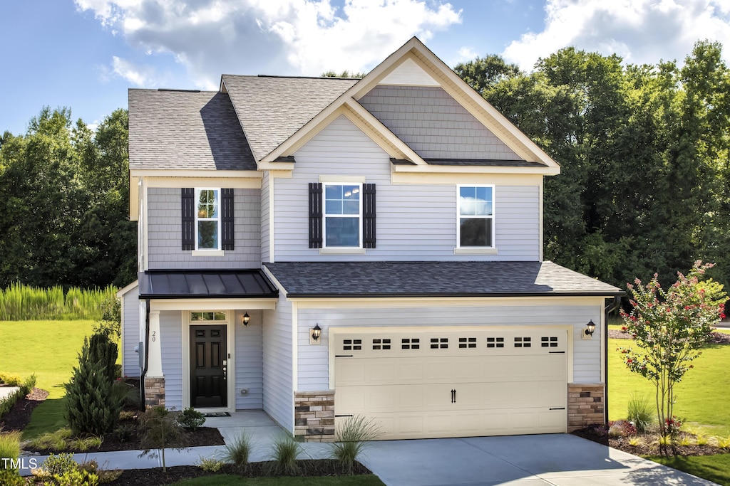 craftsman-style house featuring a garage and a front lawn