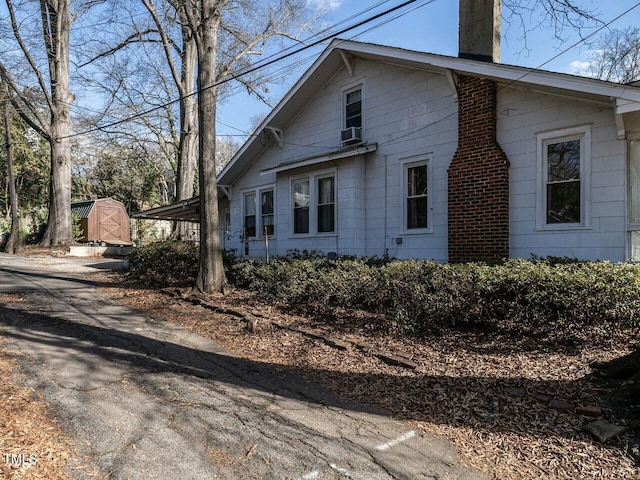 view of home's exterior with a storage unit