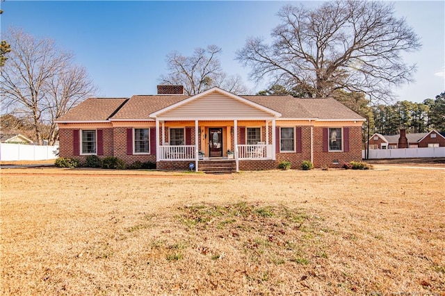 ranch-style home with a front yard and a porch