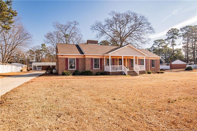 ranch-style house with covered porch and a front lawn