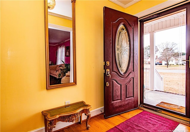 entrance foyer with crown molding and light hardwood / wood-style floors