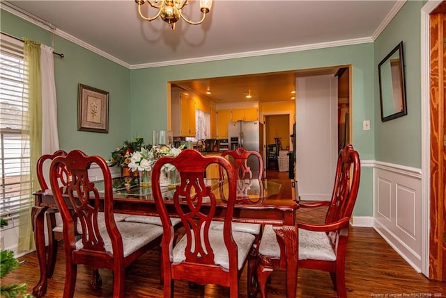 dining area with a notable chandelier, ornamental molding, hardwood / wood-style floors, and a wealth of natural light