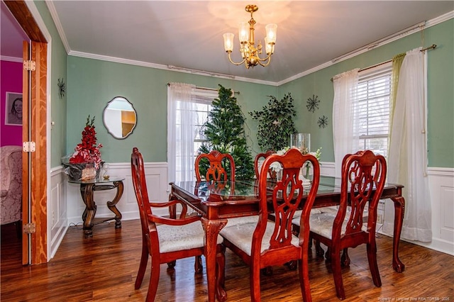 dining area featuring crown molding, dark wood-type flooring, and a chandelier