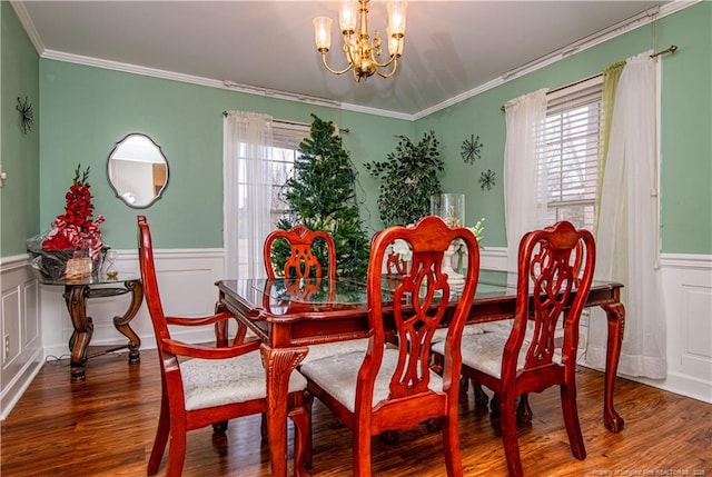 dining room with ornamental molding, dark hardwood / wood-style floors, and a notable chandelier