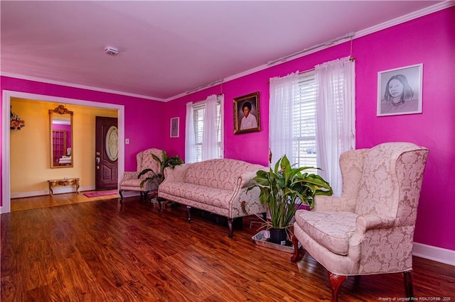 sitting room with hardwood / wood-style flooring and ornamental molding