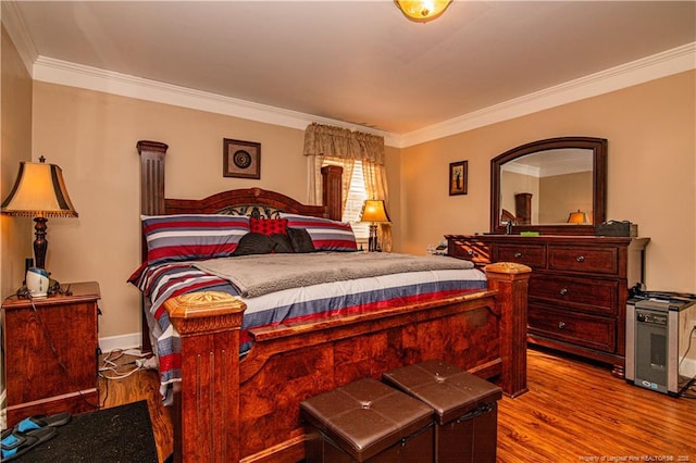 bedroom featuring crown molding and light wood-type flooring