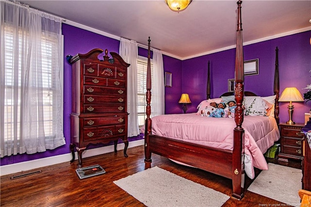 bedroom with crown molding and dark hardwood / wood-style floors