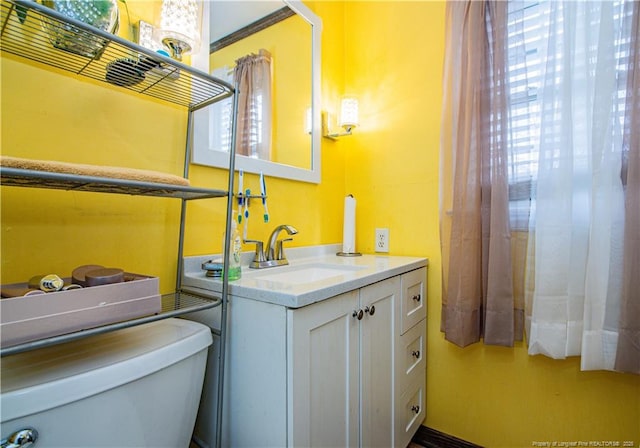 bathroom featuring vanity and toilet