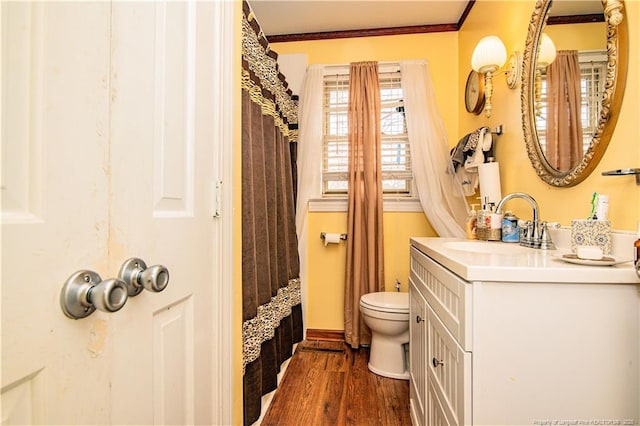 bathroom with curtained shower, hardwood / wood-style flooring, vanity, toilet, and crown molding