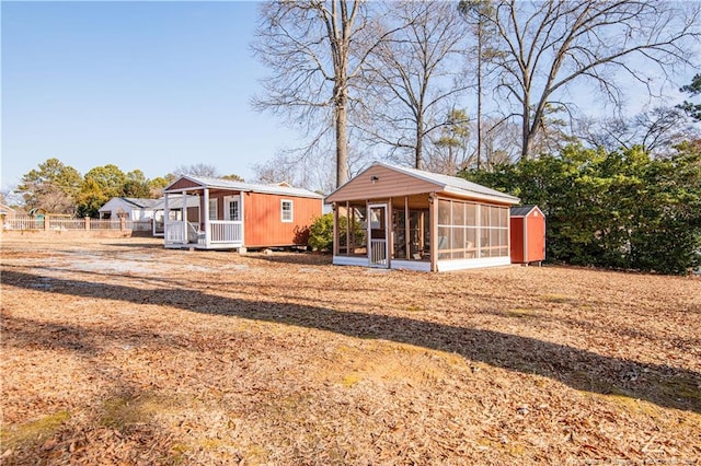 back of house featuring an outbuilding