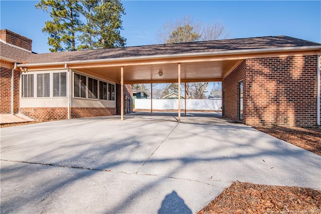 exterior space featuring a carport and a sunroom