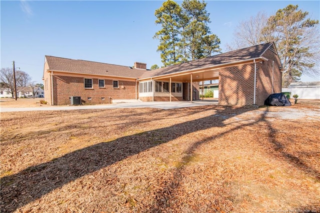 back of property featuring a carport and a patio area