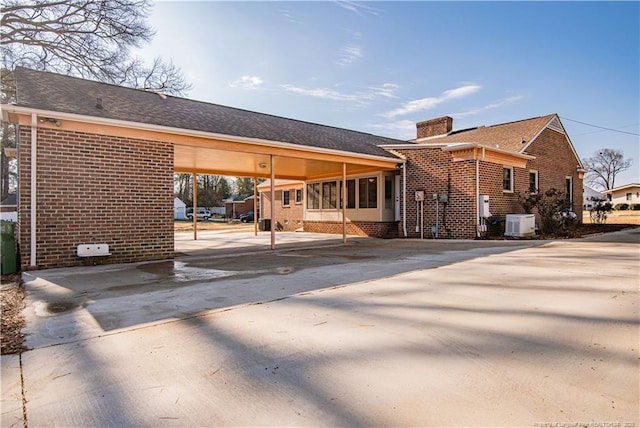 rear view of property featuring a carport