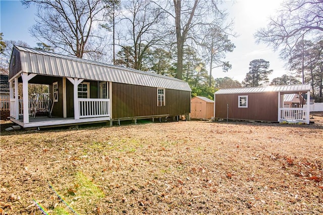 view of side of home with a storage shed