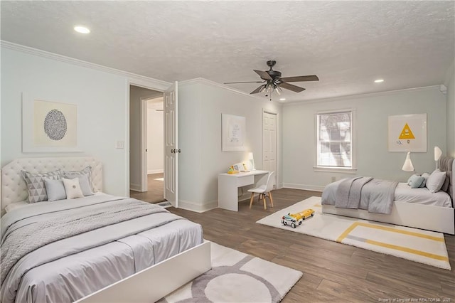 bedroom featuring dark hardwood / wood-style flooring, ornamental molding, a textured ceiling, and ceiling fan