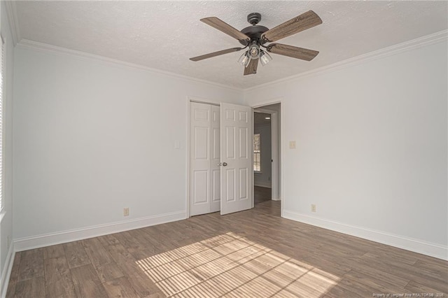 spare room featuring ornamental molding, wood-type flooring, a textured ceiling, and ceiling fan