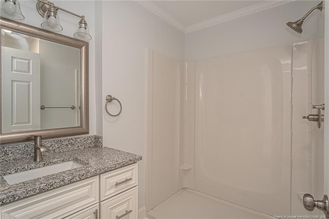 bathroom featuring crown molding, vanity, and a shower