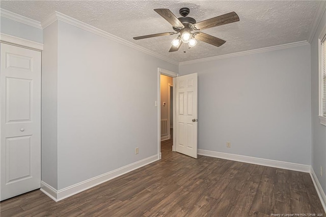 unfurnished bedroom with crown molding, dark hardwood / wood-style floors, a closet, and ceiling fan