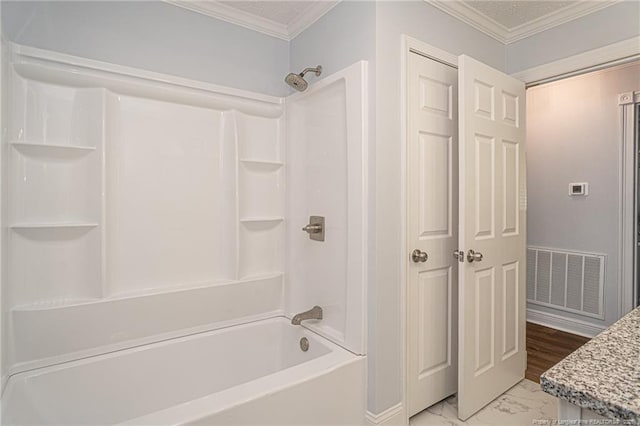 bathroom with crown molding, vanity, and shower / bathing tub combination