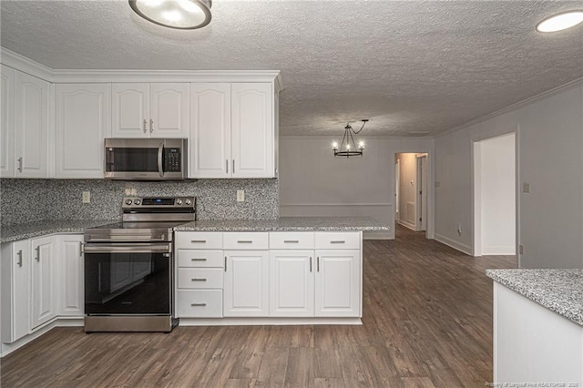 6628 Camden Rd, Fayetteville, NC 28306 - kitchen featuring stainless steel appliances, white cabinets, a chandelier, dark wood finished floors, and light stone countertops