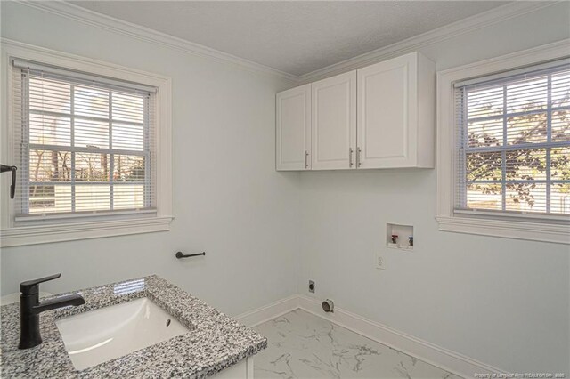 6628 Camden Rd, Fayetteville, NC 28306 - laundry area featuring hookup for a washing machine, cabinet space, light marble finish flooring, baseboards, and ornamental molding