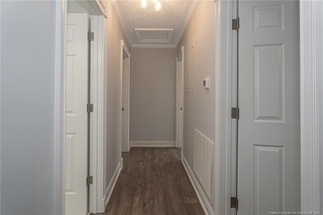 6628 Camden Rd, Fayetteville, NC 28306 - hallway featuring crown molding, dark wood-style floors, baseboards, attic access, and a textured ceiling