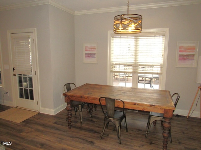 dining space featuring ornamental molding, dark wood-type flooring, and a notable chandelier