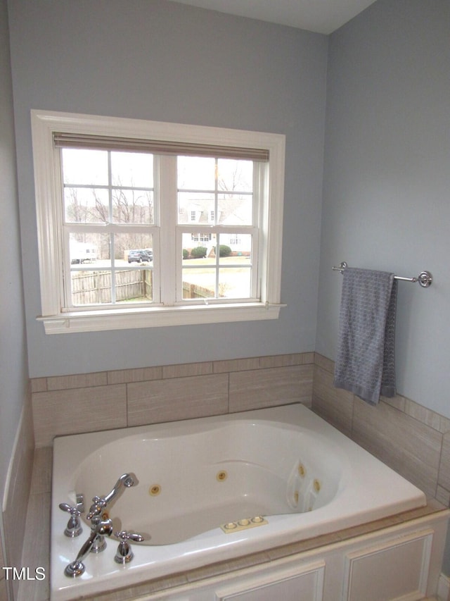 bathroom with a washtub and a healthy amount of sunlight