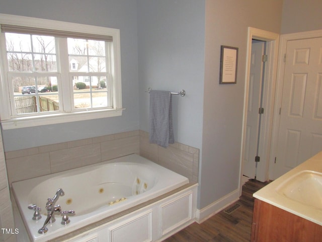 bathroom featuring vanity, a bathing tub, and hardwood / wood-style floors